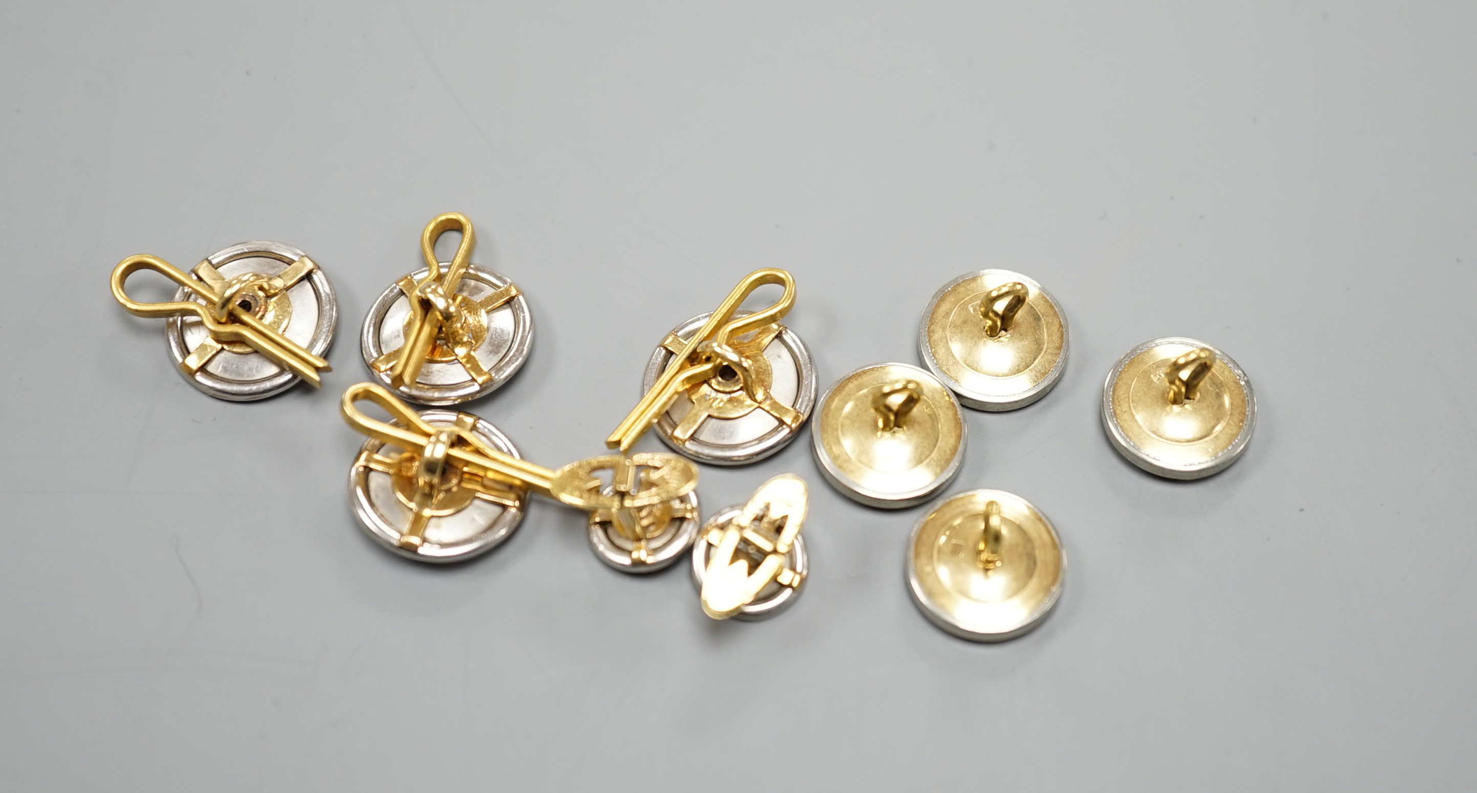 A pair of small pair of yellow and white metal diamond set cufflinks and four similar dress studs and four other yellow metal and black enamel? dress studs, gross weight 22.6 grams